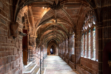 Fototapeta na wymiar Stone walkway with ornate arched ceiling inside a cathedral