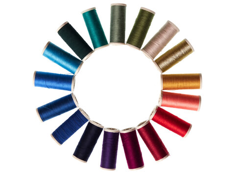 Spools with colored sewing thread on white background