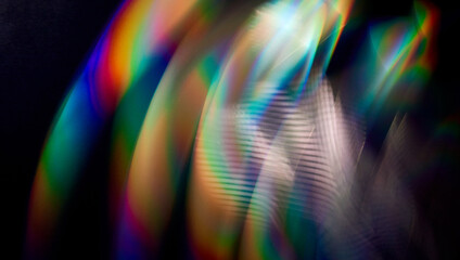 Blurred bright rainbow light. Lens or prism dynamic flare. Draving shiny spots. Dark background....