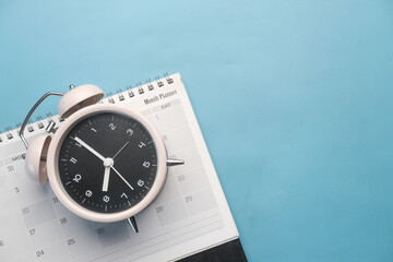 deadline concept with calendar and alarm clock purple background 
