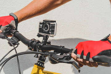 Waterproof action camera on bike handlebars. light wall background.