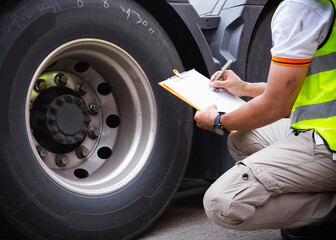 Auto Mechanic is Checking the Truck's Safety Maintenance Checklist. Lorry Fixing. Truck Inspection...