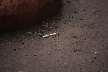 cigarette lies on the ground