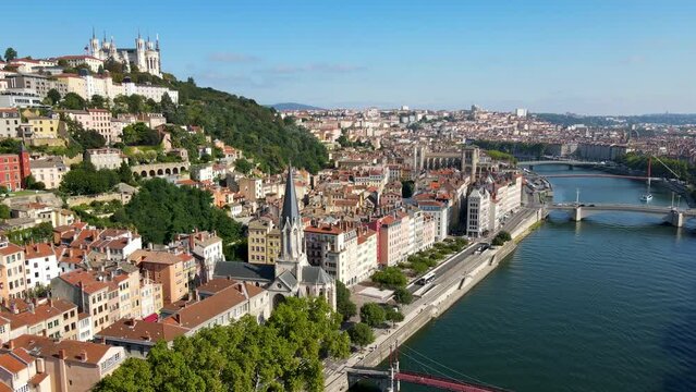 Fourviere basilica and St-Georges church in Lyon historical city center, France. Aerial footage of famous touristic landmarks, French city of lights. Sunny warm summer day, blue sky. Saone river.