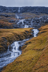Fototapeta na wymiar Europe, Faroe Islands. View of the village of Saksun and waterfalls on the island of Streymoy. November 2021