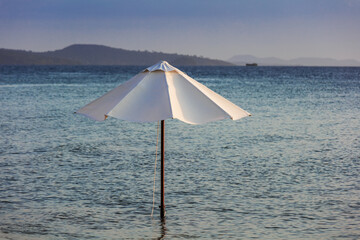 beautiful white umbrella in ocean