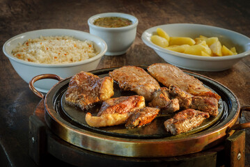 Barbecue. Brazilian picanha barbecue grilled with meat mix on aged wooden table.