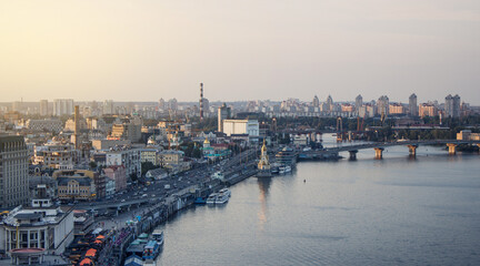 Kyiv, Ukraine. View of the embankment, bridges and Dnipro river, Podil in the evening.