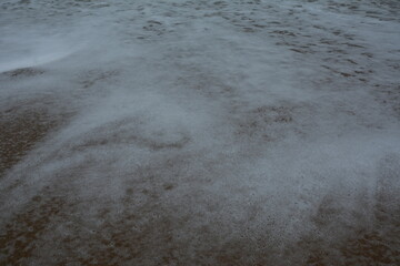 water flowing into the ocean after a wave has passed - mesmerizing and hypnotic to observe
