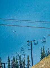 Mountain chairlift and surveillance helicopter.