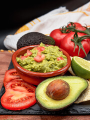 Homemade Organic Guacamole, tomatoes and Tortilla Chips. Selective focus.