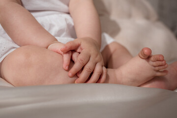 close-up of the child's hands lying on his knees