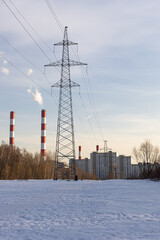  transmission line tower stands in a snowy field