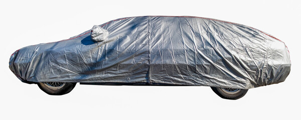 Passenger car covered with silver fabric. Isolated.