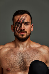 Fototapeta premium Animal instinct fitness instructor sportsman showing his incredible flexibility with an animal flow move in studio against a gray background