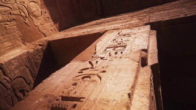 Camera rotates arounda pillar, looking up at the carved hierogplyhs in the Kamak Temple in Luxor, Egypt. 