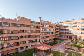 Facades of residential houses with views of the common areas with gardens and playground