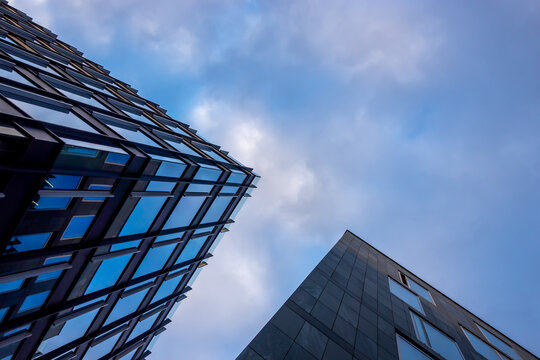 Facade of a modern apartament building against a blue sky background. Photo taken at late afternoon on a sunny day.