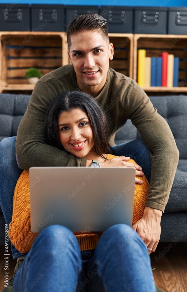 Canvas Prints man and woman couple hugging each other using laptop at home - Canvas Prints