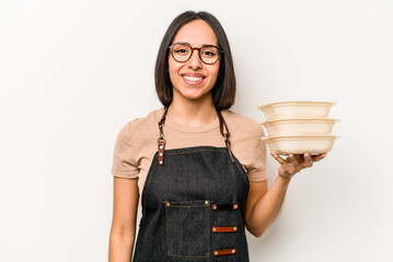 Young caucasian waitress woman holding tupperware isolated on white background happy, smiling and cheerful.