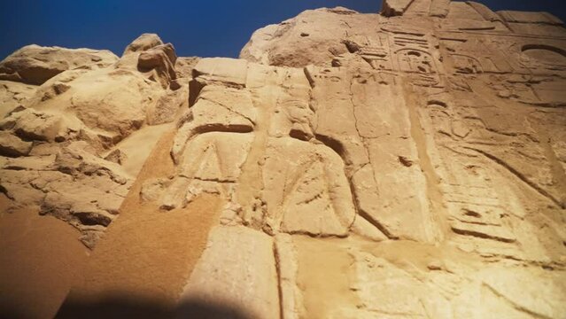 Kings and hieroglyphs carved into rock outside of the Karnak Temple, in Luxor Egypt.
Slow camera movement.