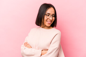 Fototapeta premium Young hispanic woman isolated on pink background laughing and having fun.