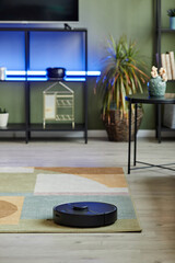 Vertical background image of robot vacuum cleaner in smart home with led light setup, copy space