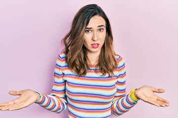 Young hispanic girl wearing casual clothes clueless and confused with open arms, no idea concept.
