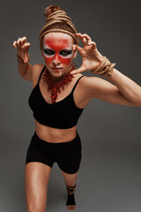 close up portrait of young beautiful girl with colorful face painting. Halloween professional makeup. neck and hands are wrapped with ropes. Victim Concept