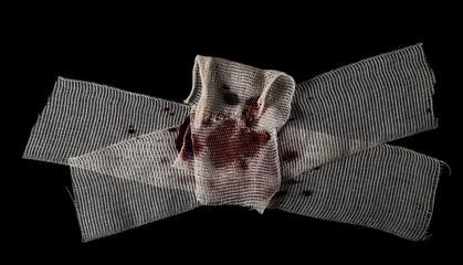 Bloody medical bandages isolated on black