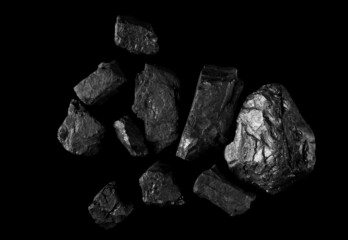 Pile black coal isolated on black, clipping path and top view