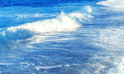 Defocused sea background with waves. Blue clear water.