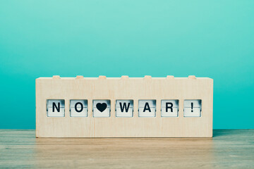 text no war in a wooden split flap board