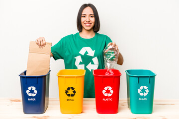 Young hispanic woman recycling isolated on white background