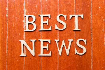 Alphabet letter in word best news on old red color wood plate background