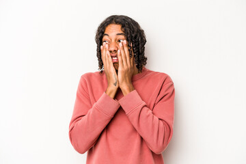 Young African American man isolated on white background scared and afraid.