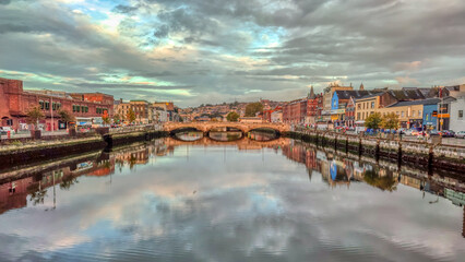 Fototapeta premium Morning view in Cork City Ireland business and classic buildings with reflection on the river