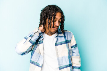 Young African American man isolated on blue background suffering neck pain due to sedentary...