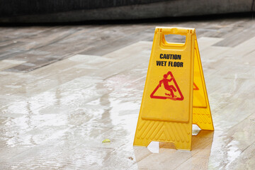 caution wet floor sign on wet floor after raining. - obrazy, fototapety, plakaty