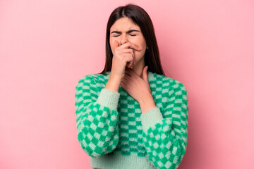 Young caucasian woman isolated on pink background suffers pain in throat due a virus or infection.