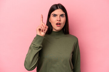 Young caucasian woman isolated on pink background having an idea, inspiration concept.