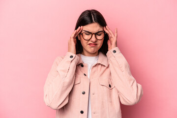 Young caucasian woman isolated on pink background having a head ache, touching front of the face.