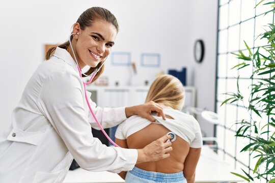 Woman and girl pediatrician and patient auscultating having medical consultation at clinic