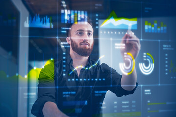Businessman working on digital display in control room at office