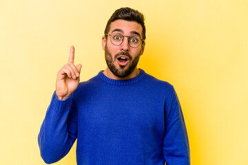 Young caucasian man isolated on yellow background having an idea, inspiration concept.