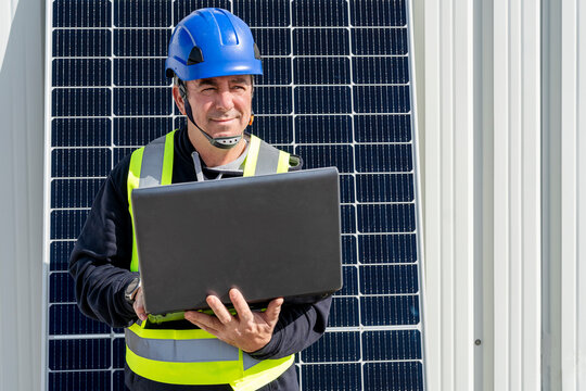 Thoughtful engineer with laptop at solar power station