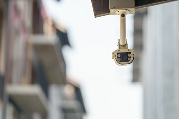 CCTV surveillance security camera on a black pole with blue sky background..