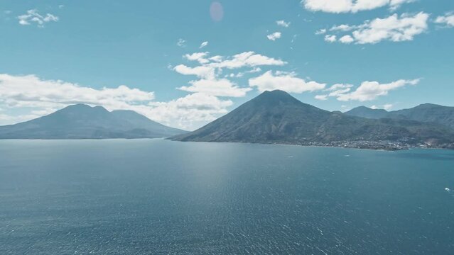 Atilan lake surroundings - Volcanoes on one side and small town on other. Aerial rotate view