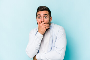 Young caucasian man isolated on blue background scared and afraid.