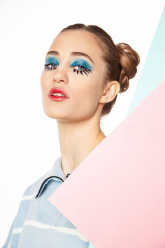 Woman with creative eye make-up posing in studio